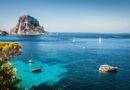 Türkisblaues Meer mit Segelbooten und luxuriöser Yacht vor der Küste Ibizas, im Hintergrund der imposante Felsen Es Vedrà – idealer Ort für Beach Restaurants Ibiza.